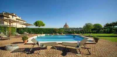 a swimming pool with two lounge chairs at Dimora della Luna in Rome