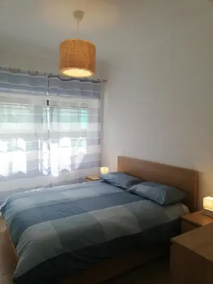 a bedroom with a blue bed and a window at Vacanze romane in Rome