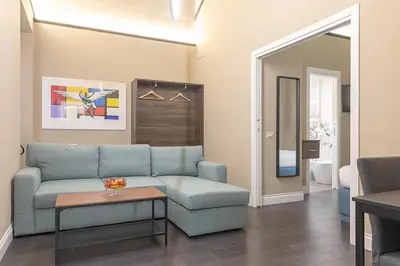 a living room with a couch and a table at Dei Greci Guesthouse in Rome