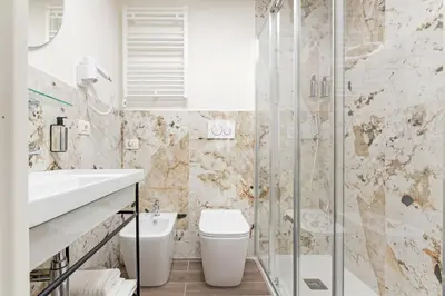 a bathroom with a toilet and a sink and a shower at Dei Greci Guesthouse in Rome