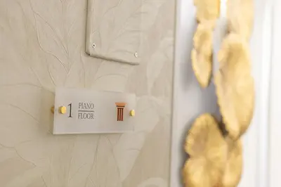 a lightswitch on a wall with a sign on it at Dei Greci Guesthouse in Rome