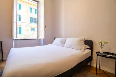 a bedroom with a white bed with a window at Cunabu Emilio in Rome