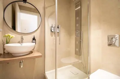 a bathroom with a shower and a sink and a mirror at Cunabu Emilio in Rome