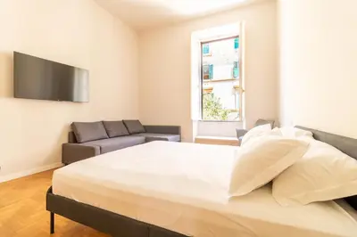 a bedroom with a large bed and a couch at Cunabu Emilio in Rome
