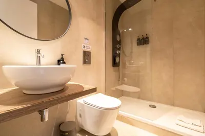 a bathroom with a sink and a toilet and a shower at Cunabu Emilio in Rome