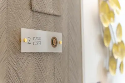 a sign on a door with a knob on it at Maison dei Greci in Rome