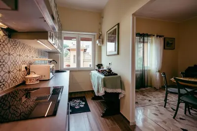 a small kitchen with a table and a window at Eleganza e Arte a Città Giardino 5' Metro B in Rome