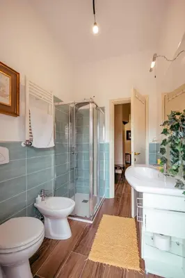 a bathroom with a toilet and a sink and a shower at Eleganza e Arte a Città Giardino 5' Metro B in Rome