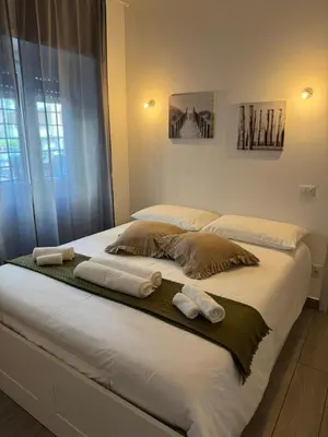 a bedroom with two beds with towels on them at Angoletto di Mirtilla in Rome