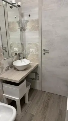 a bathroom with a sink and a toilet and a mirror at Angoletto di Mirtilla in Rome
