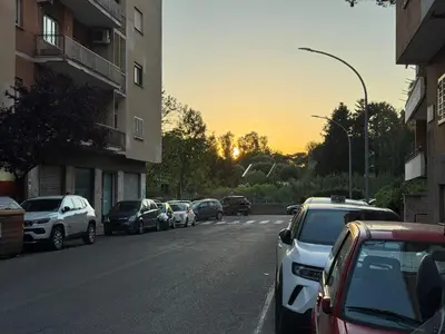 a street with cars parked on the side of the road at Angoletto di Mirtilla in Rome