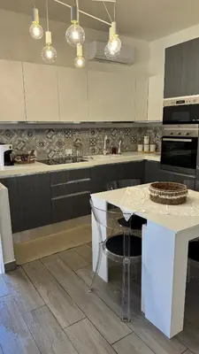 a kitchen with a counter and a island in it at Angoletto di Mirtilla in Rome