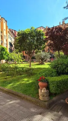 a park with a pot of flowers and trees at Wonderful Garden at Colosseo in Rome