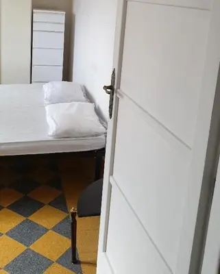 a bedroom with a bed and a white door at Camera con vista MetroA in Rome