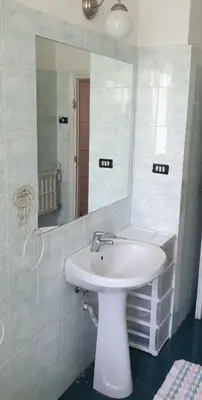 a bathroom with a white sink and a mirror at Camera con vista MetroA in Rome