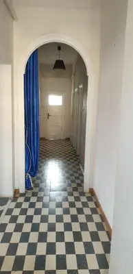 an empty hallway with a checkered floor and a door at Camera con vista MetroA in Rome