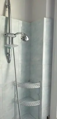 a shower with a glass door with a metal shower at Camera con vista MetroA in Rome