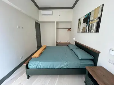 a bedroom with a green bed in a room at Home Domus Castel Sant'Angelo in Rome