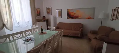 a living room with a table and a couch at MURA DI PRATI - Spazioso appartamento per 8 a San Pietro in Rome