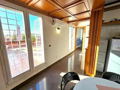 a room with large windows and a table and chairs at Rooftop Marconi in Rome