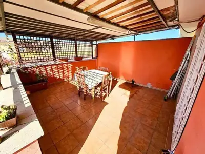 a balcony with a table and chairs in a building at Rooftop Marconi in Rome