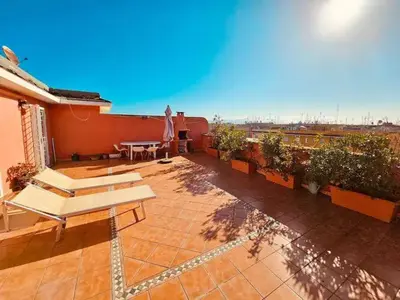 a patio with a table and some plants on a building at Rooftop Marconi in Rome