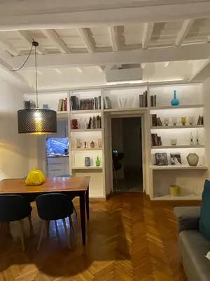 a living room with a table and chairs and a couch at carpe diem sistina in Rome