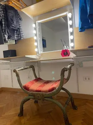 a chair in a room with a mirror at carpe diem sistina in Rome