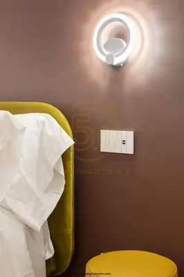 a bedroom with a light on the wall at cinquepuntozero in Rome