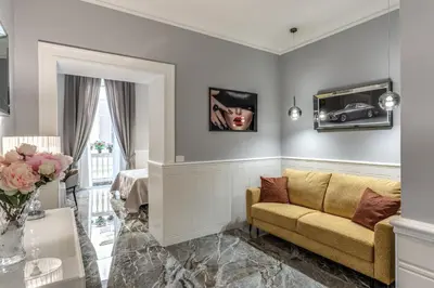 a living room with a couch and a table at Spanish Steps Oasis Suite in Rome