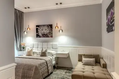 a bedroom with a bed and a desk and a couch at Spanish Steps Oasis Suite in Rome
