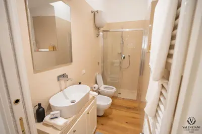 a bathroom with a sink and a toilet and a shower at Valenziani Luxury Central Rome in Rome