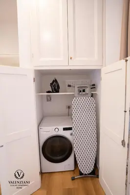 a white laundry room with a washing machine in it at Valenziani Luxury Central Rome in Rome