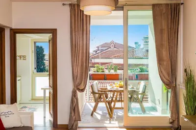 a living room with a table and a glass door at Boutique Domus Trastevere Family in Rome