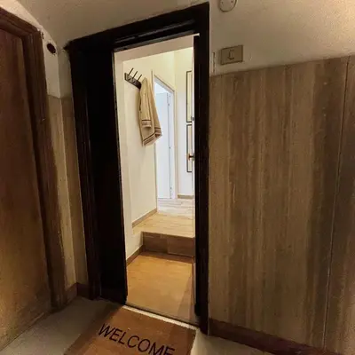 an open door to a room with a hallway with a welcome sign at Casa Campani 56 in Rome
