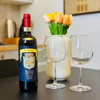 a bottle of wine next to two wine glasses at Casa Campani 56 in Rome