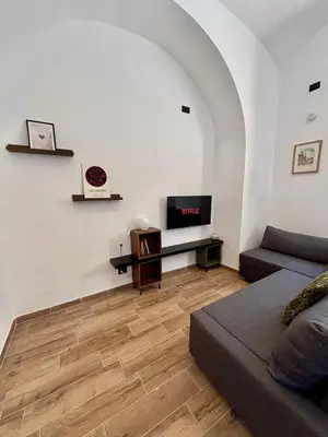 a living room with a couch and a flat screen tv at Casa Campani 56 in Rome