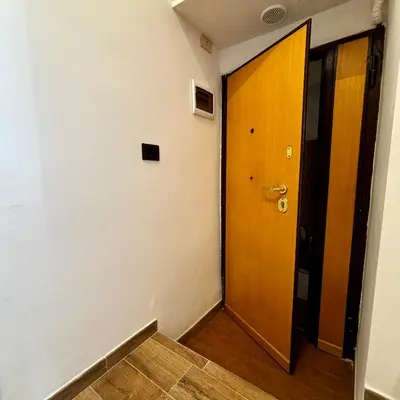 a hallway with a wooden door and a wooden floor at Casa Campani 56 in Rome