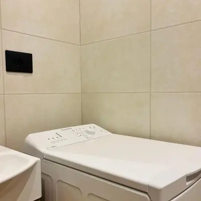 a bathroom with a washing machine and a sink at Casa Campani 56 in Rome