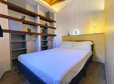 a bedroom with a large bed with shelves at ERA Trastevere in Rome