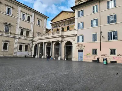 a person standing in front of a large building at ERA Trastevere in Rome
