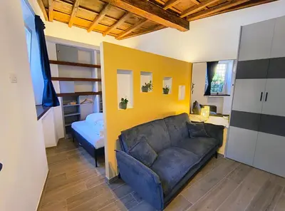 a living room with a couch and a bed at ERA Trastevere in Rome