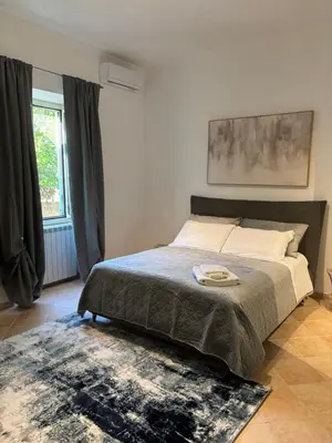 a bedroom with a large bed and a rug at Pigneto Cosmo House in Rome