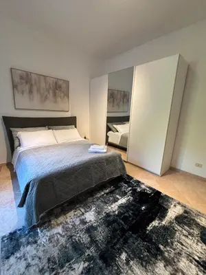 a bedroom with a large bed and a mirror at Pigneto Cosmo House in Rome