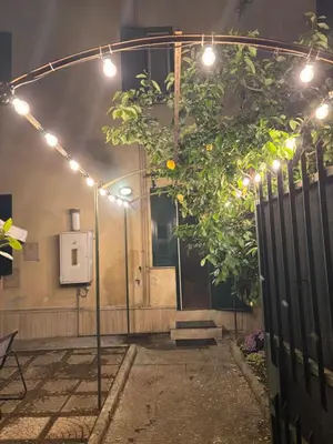 a patio with a tree with lights on it at Pigneto Cosmo House in Rome