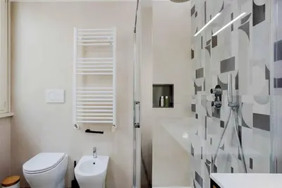 a white bathroom with a toilet and a shower at Your dream in Rome San Paolo in Rome