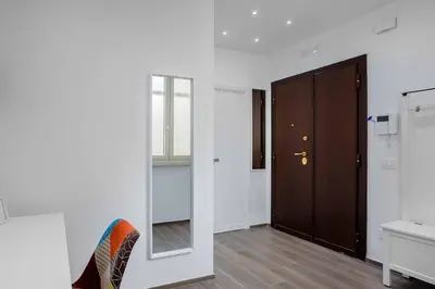 a room with a mirror and a wooden door at Your dream in Rome San Paolo in Rome