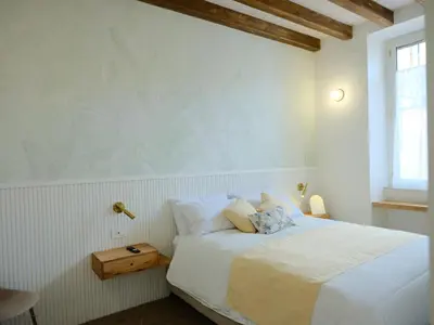 a white bedroom with a bed and a window at GG Vatican Townhouse in Rome