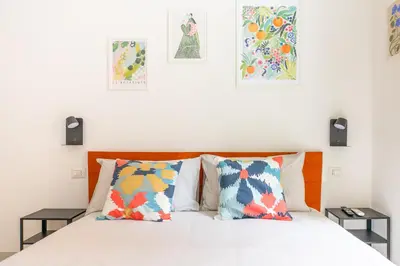 a bedroom with a bed with three pictures on the wall at Ospiti di Jole al Pigneto in Rome