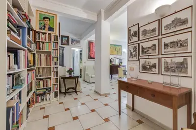 a library with bookshelves and a desk in a room at Casa Marino Roma in Rome